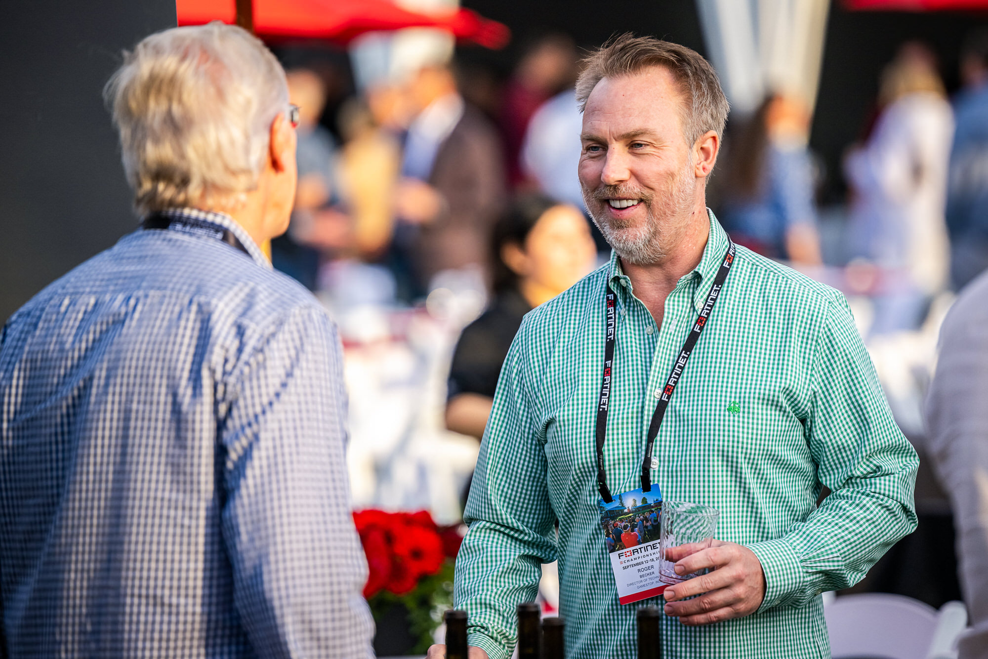 Two guests chatting over drinks at a welcome reception
