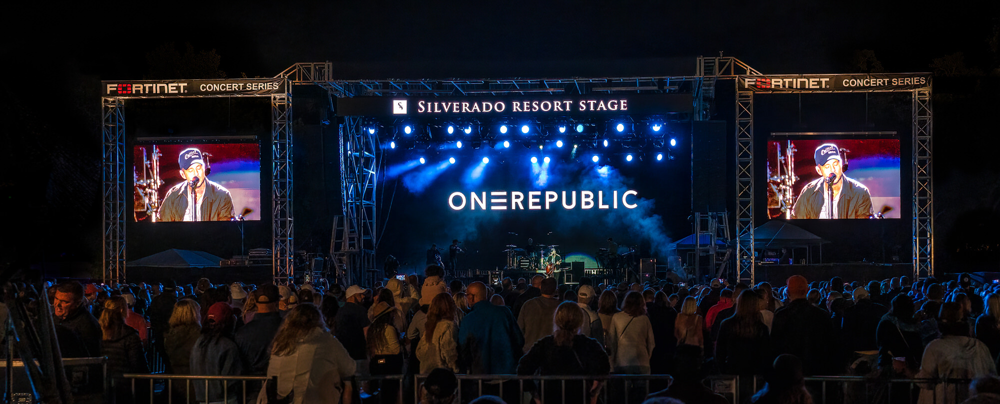 Headline act on an outdoor stage flanked by two video screens