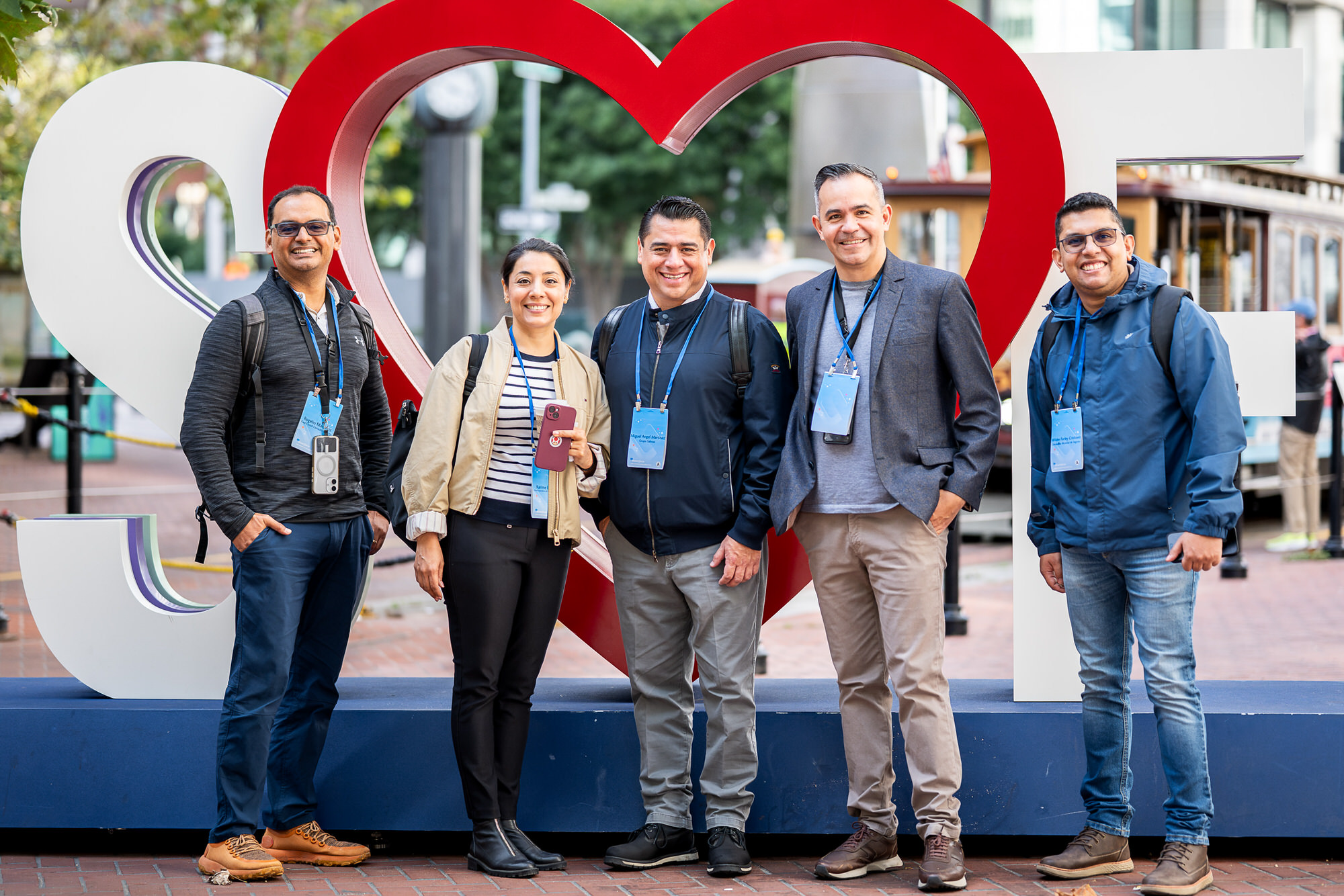 Group of attendees posing for a portrait in front of an SF heart sign