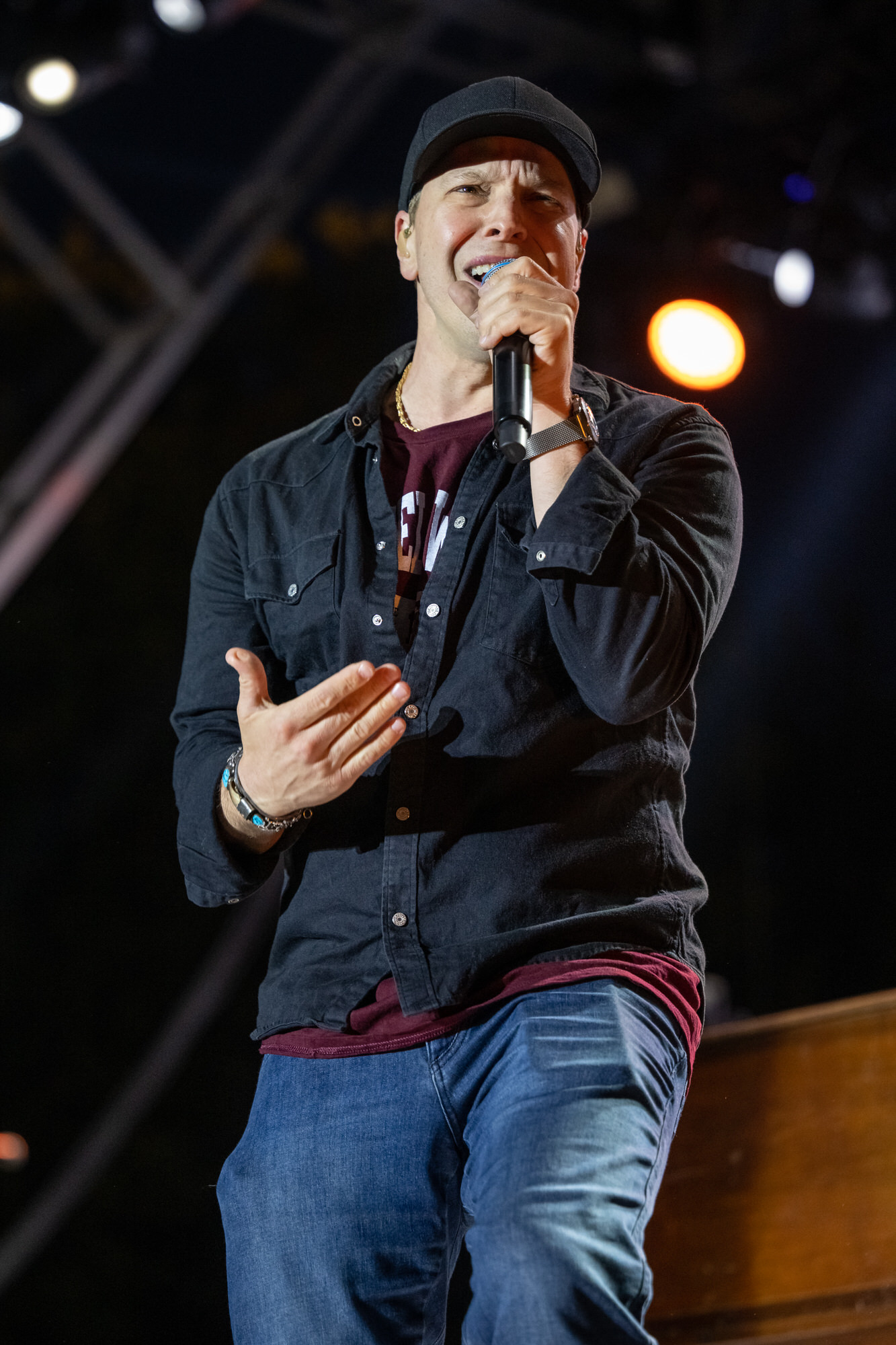 Singer performing under the stage lighting rig