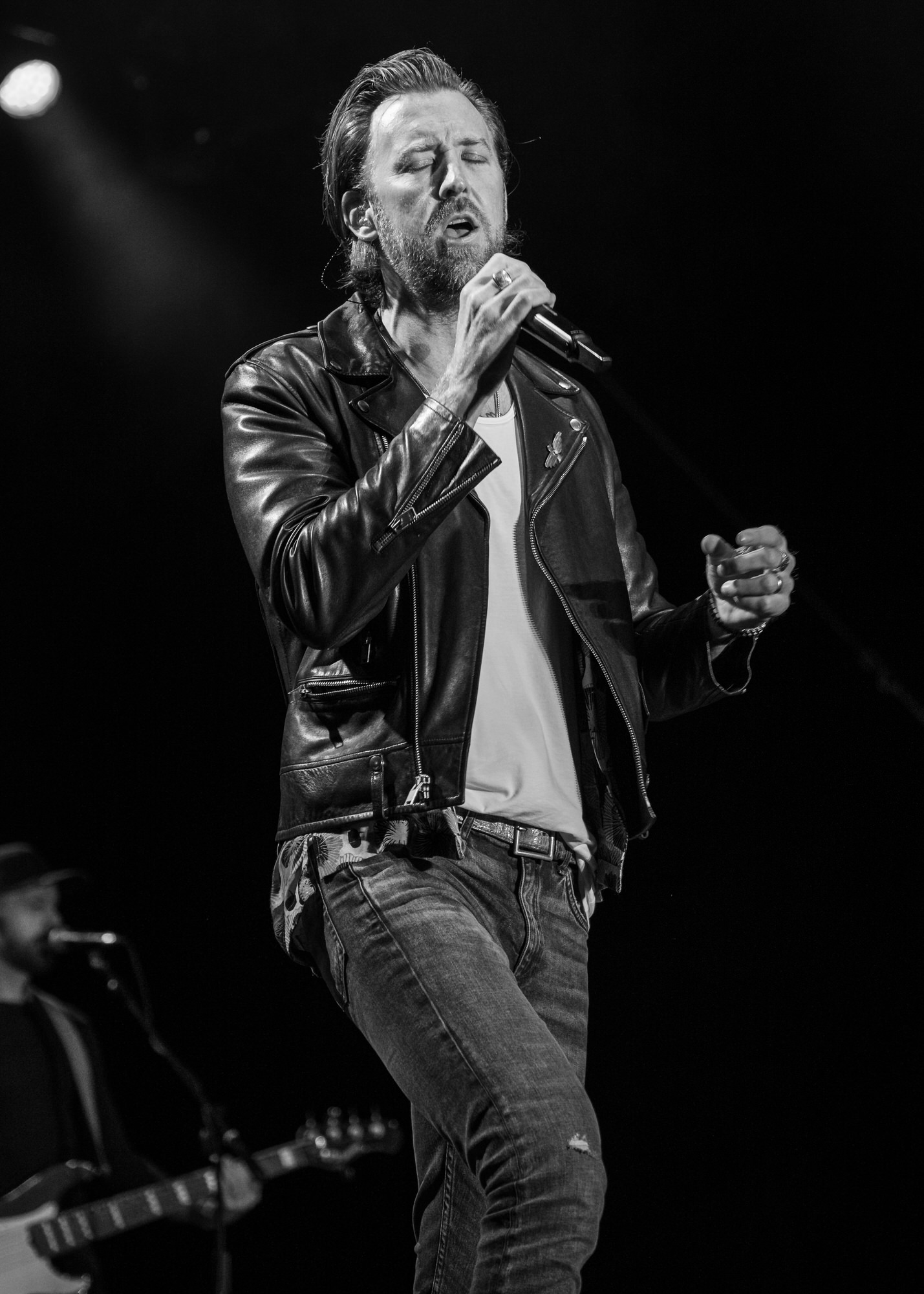 Black-and-white photo of a singer in a leather jacket