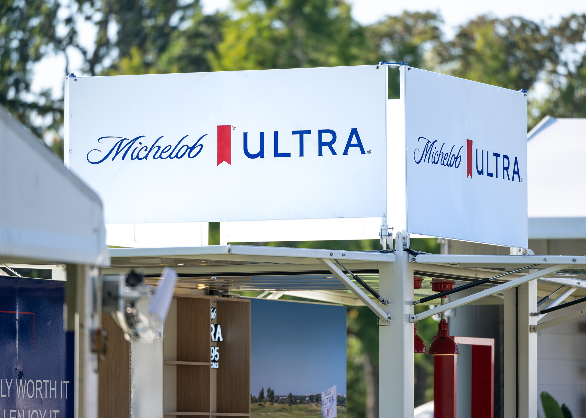 Branded sponsor bar kiosk in an outdoor hospitality area